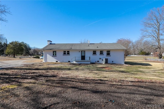 rear view of house with a yard and central AC