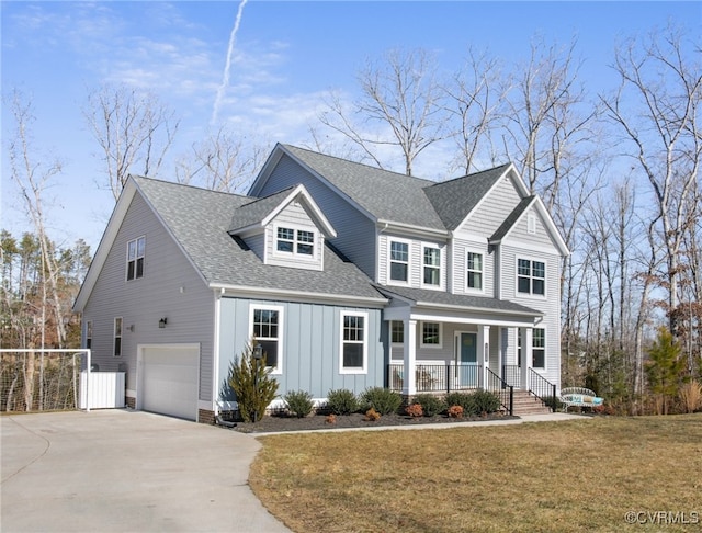 front facade featuring cooling unit, a porch, a garage, and a front yard