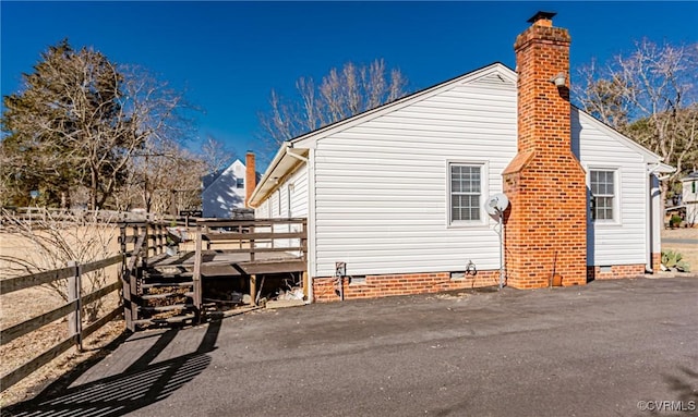 view of property exterior featuring a deck