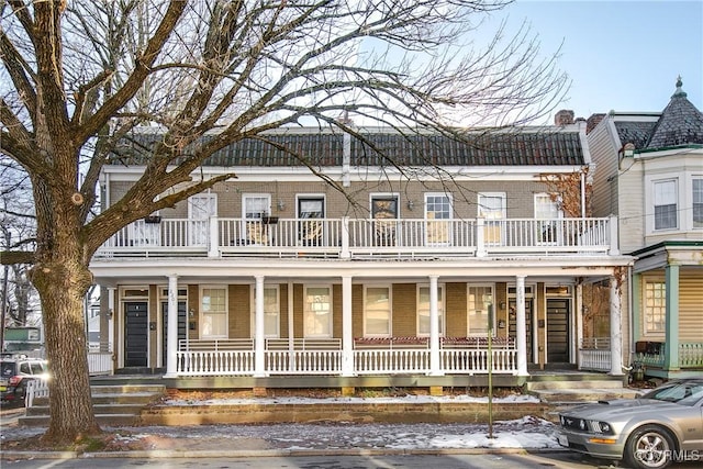 view of front facade featuring a balcony and covered porch