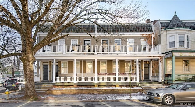 view of front of home featuring a balcony and covered porch