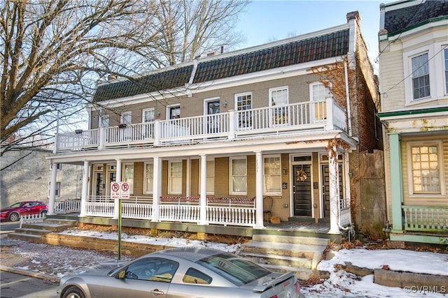 view of front of house featuring a balcony and a porch