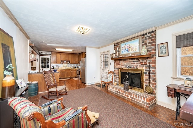 living room featuring crown molding, a fireplace, and a textured ceiling