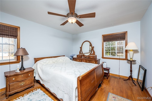 bedroom with ceiling fan and light hardwood / wood-style floors