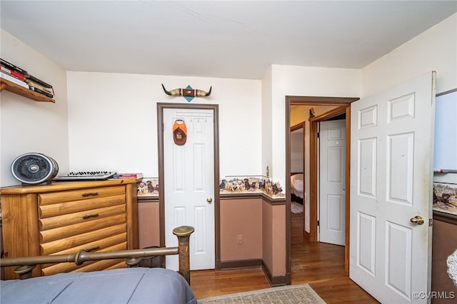 bedroom with dark wood-type flooring