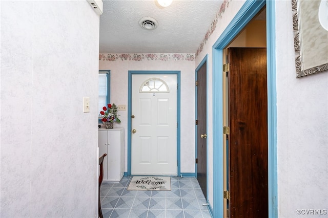 foyer entrance featuring a textured ceiling