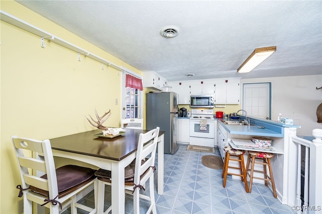 interior space with sink and a textured ceiling