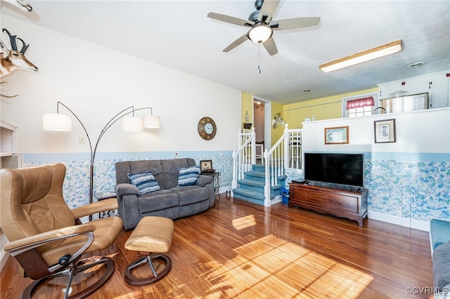 living room featuring hardwood / wood-style flooring and ceiling fan