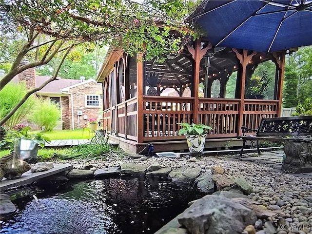 exterior space featuring a garden pond and a deck