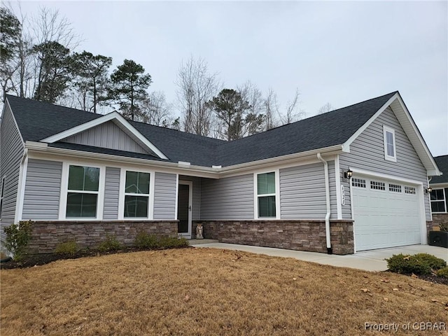 view of front of property featuring a garage and a front lawn