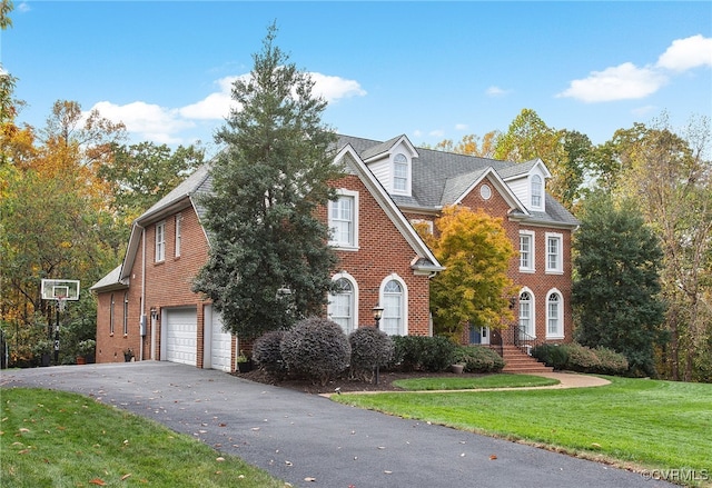 view of front of home with a garage and a front lawn