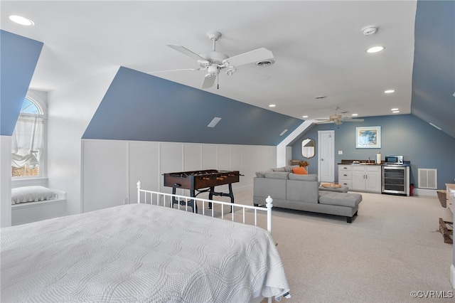 carpeted bedroom with wine cooler, vaulted ceiling, and ceiling fan