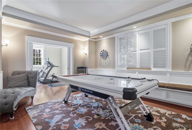 playroom with hardwood / wood-style flooring, crown molding, and a tray ceiling