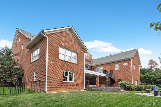 rear view of property featuring a lawn