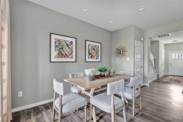 dining space with hardwood / wood-style floors