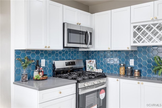 kitchen with tasteful backsplash, stainless steel appliances, and white cabinets