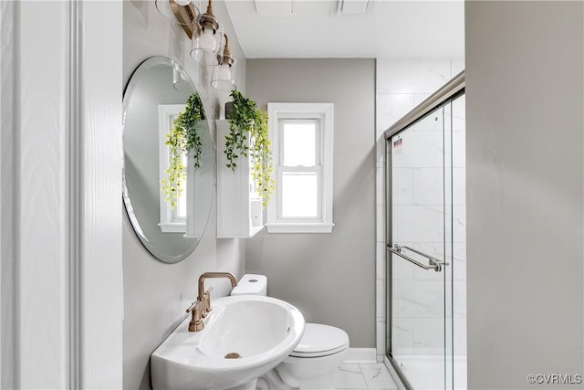 bathroom with walk in shower, toilet, and sink