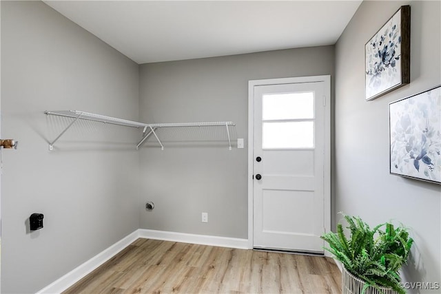 laundry area with light hardwood / wood-style floors