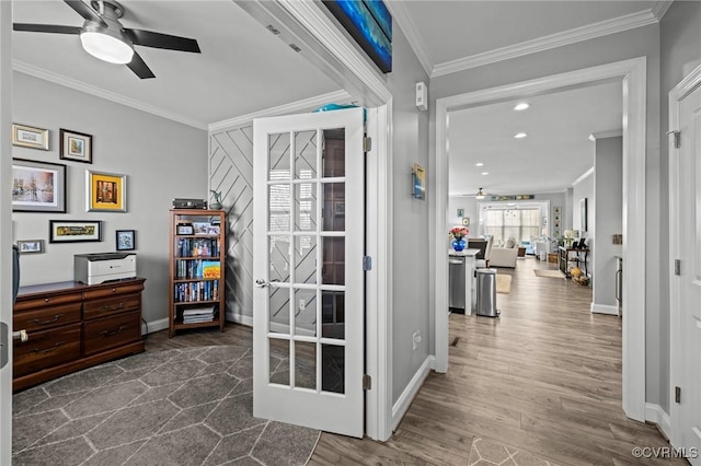 interior space with dark wood-style floors, ceiling fan, ornamental molding, and baseboards