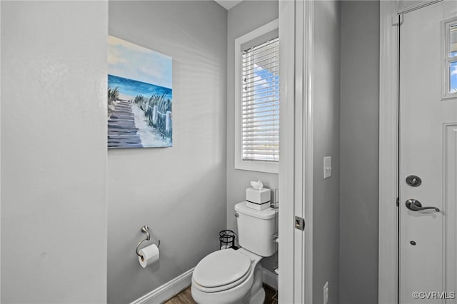 bathroom featuring toilet and baseboards