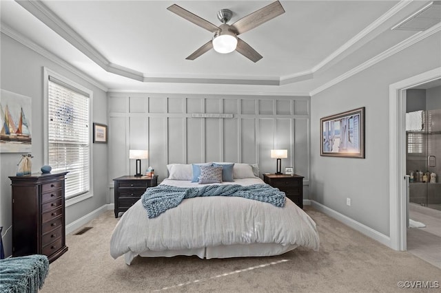 carpeted bedroom featuring ornamental molding, a raised ceiling, and visible vents