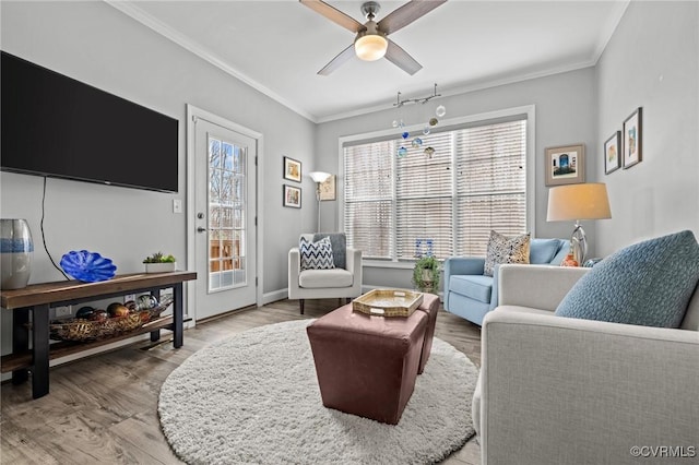 living area featuring plenty of natural light, ornamental molding, and wood finished floors