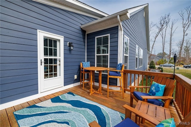 wooden deck featuring outdoor dining area