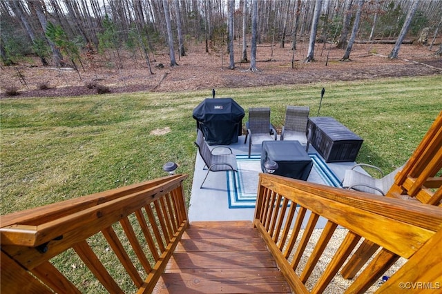 deck with a grill and a yard