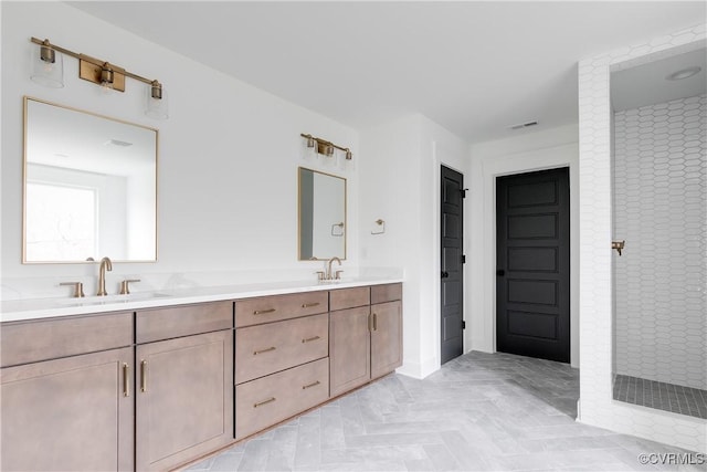 bathroom with vanity, parquet floors, and a shower