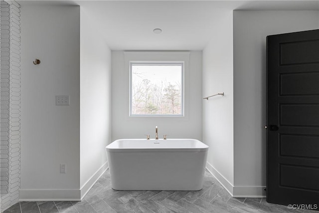 bathroom featuring a tub to relax in