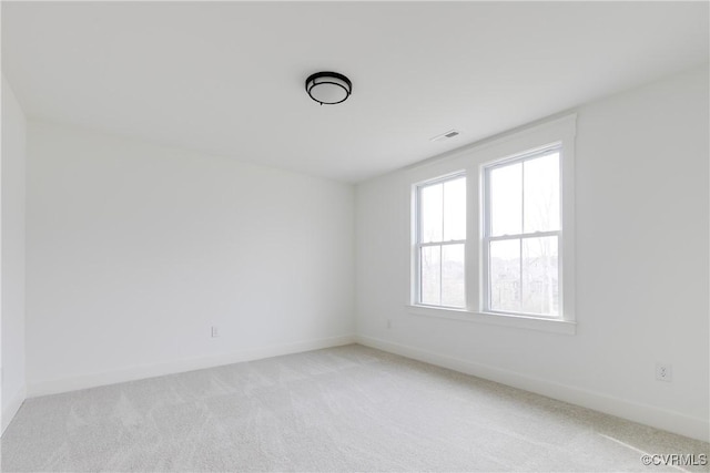 unfurnished room featuring light colored carpet