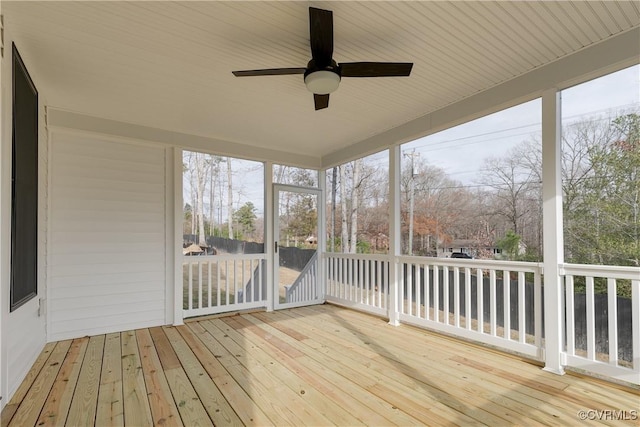 unfurnished sunroom with ceiling fan