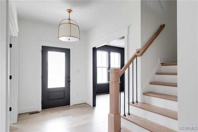 foyer entrance with light wood-type flooring