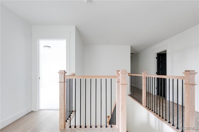 corridor with light hardwood / wood-style floors