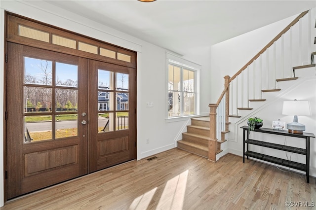 foyer entrance with french doors and light wood-type flooring