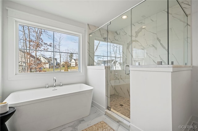 bathroom featuring plus walk in shower and a healthy amount of sunlight