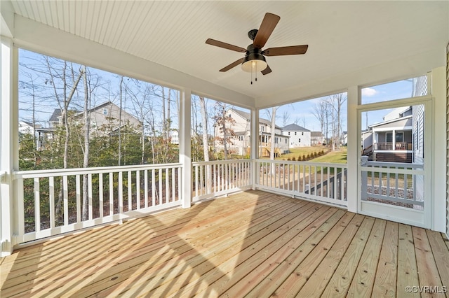 unfurnished sunroom featuring ceiling fan