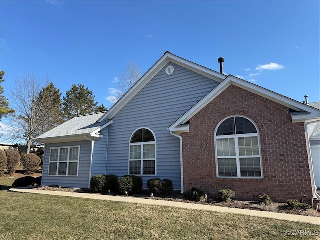 view of side of property with a yard