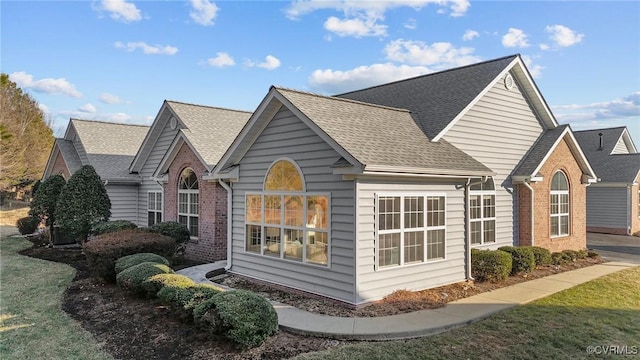 view of side of property with a lawn