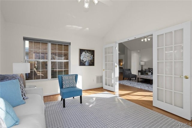 sitting room with french doors, vaulted ceiling, and hardwood / wood-style flooring