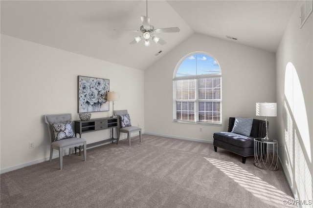 sitting room with ceiling fan, vaulted ceiling, and light carpet