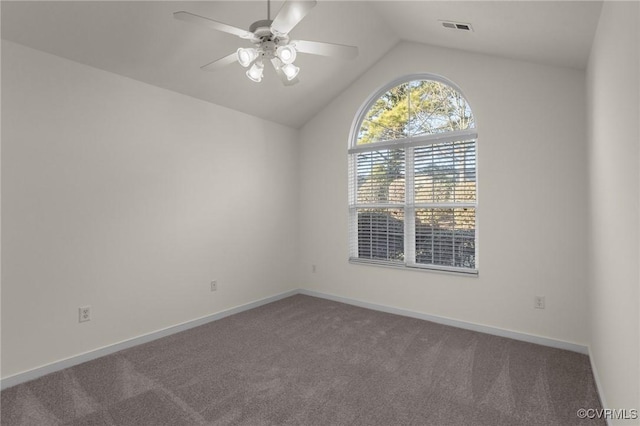 carpeted empty room with vaulted ceiling and ceiling fan