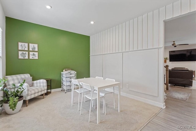 dining room with recessed lighting, an accent wall, a ceiling fan, light wood-style floors, and baseboards