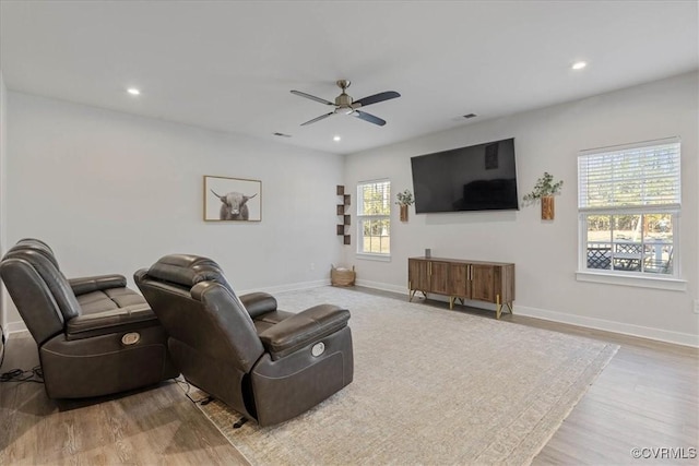 living area with recessed lighting, baseboards, and wood finished floors