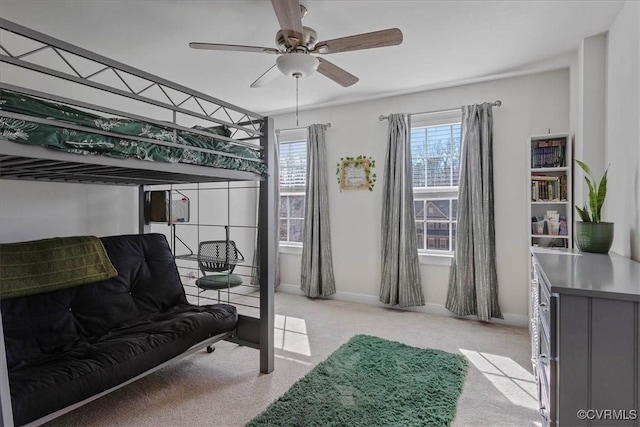 bedroom with ceiling fan, multiple windows, and light colored carpet