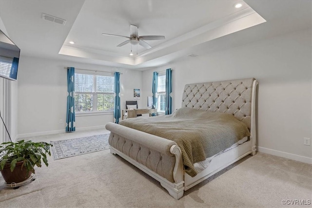 carpeted bedroom with baseboards, visible vents, a raised ceiling, a ceiling fan, and recessed lighting