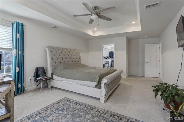 carpeted bedroom featuring a raised ceiling, visible vents, and recessed lighting