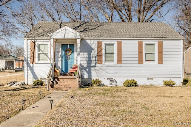 bungalow-style home featuring a front yard