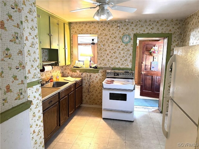 kitchen with sink, white appliances, light tile patterned floors, and ceiling fan