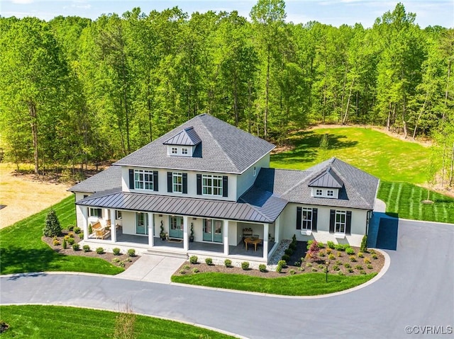 view of front of home with a porch and a front yard